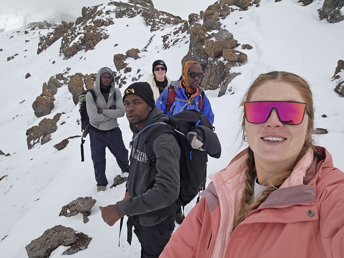 Ally Omary guiding climbers on the snowy slopes of Kilimanjaro